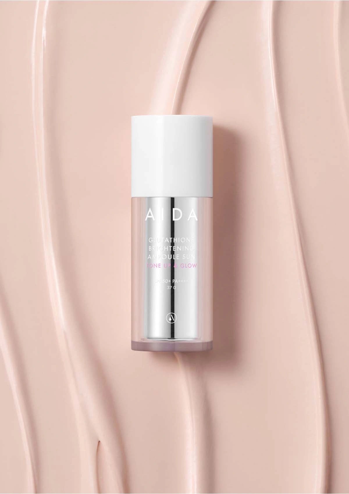 Skincare bottle with 'ALDA' branding on a pink background